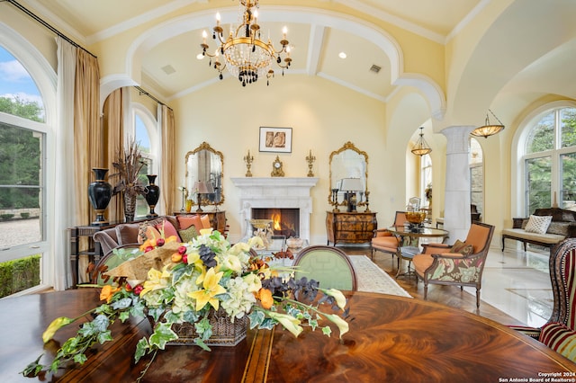 dining space with decorative columns, crown molding, wood-type flooring, and vaulted ceiling