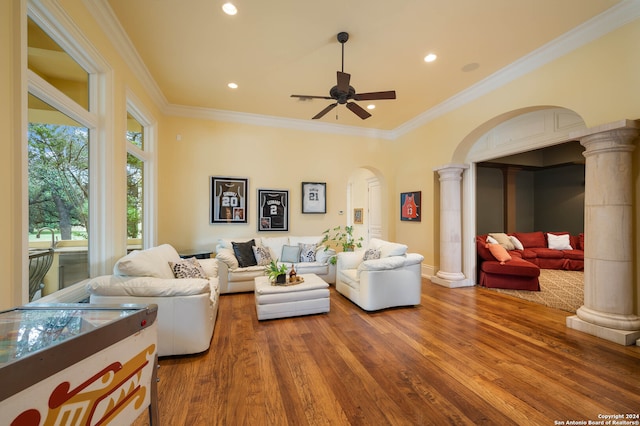 living room featuring decorative columns, crown molding, ceiling fan, and hardwood / wood-style flooring