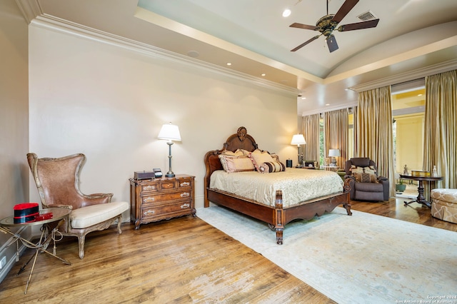 bedroom featuring hardwood / wood-style floors, ceiling fan, ornamental molding, and vaulted ceiling