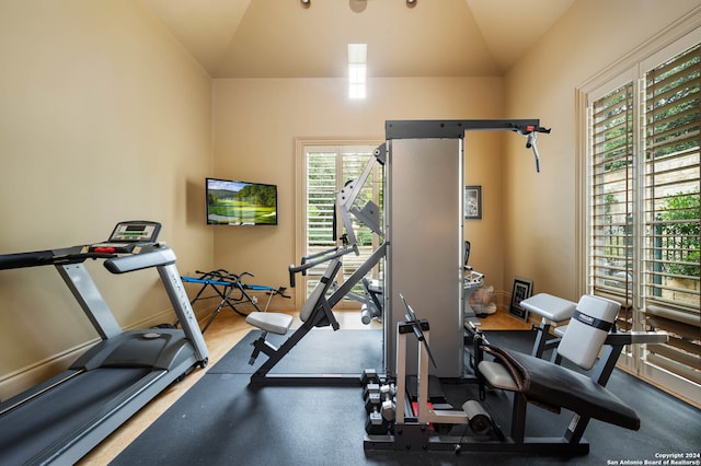 workout room featuring lofted ceiling