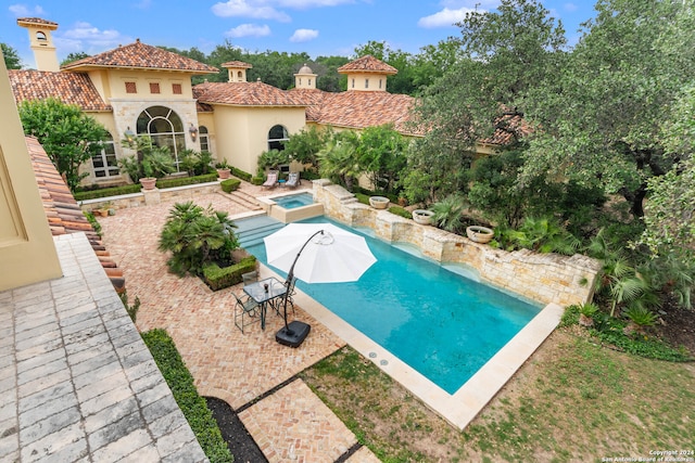 view of swimming pool with an in ground hot tub and a patio