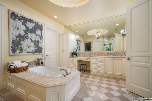 bathroom with vanity, a bathtub, and a notable chandelier