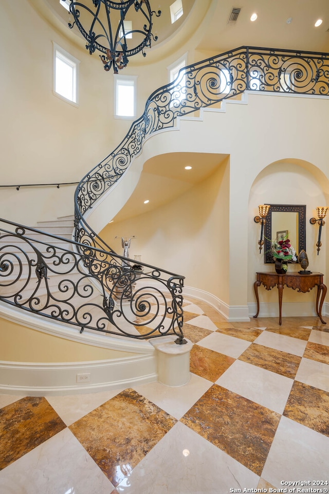 staircase featuring a high ceiling