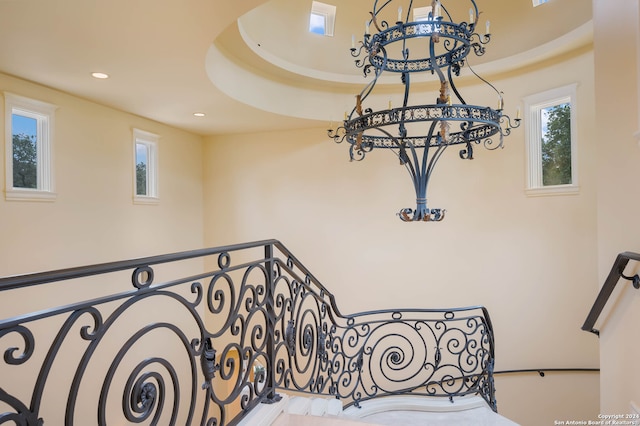 staircase featuring a tray ceiling