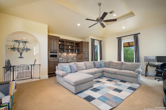 living room with light colored carpet and ceiling fan