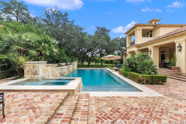 view of pool with an in ground hot tub