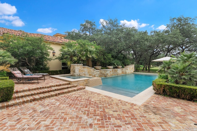 view of swimming pool with an in ground hot tub and a patio