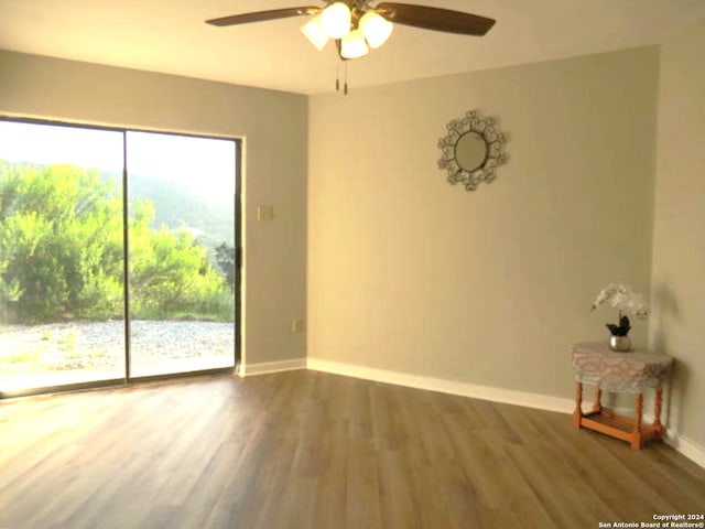 unfurnished room featuring ceiling fan and hardwood / wood-style flooring