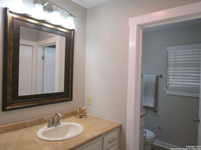 bathroom featuring vanity and toilet