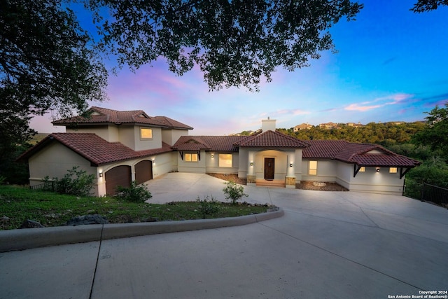 mediterranean / spanish house featuring a garage