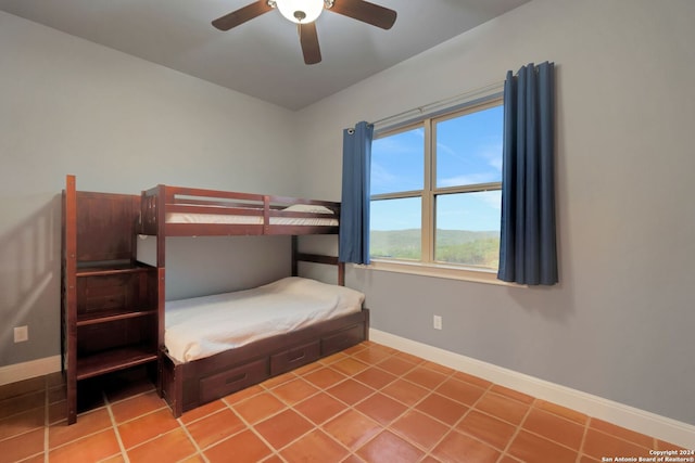 tiled bedroom featuring ceiling fan