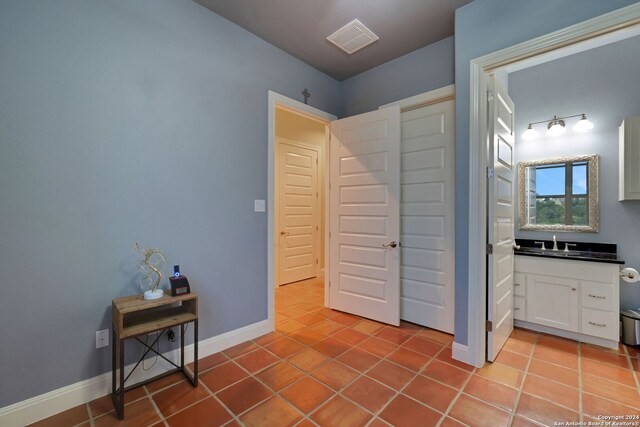 tiled bedroom with sink