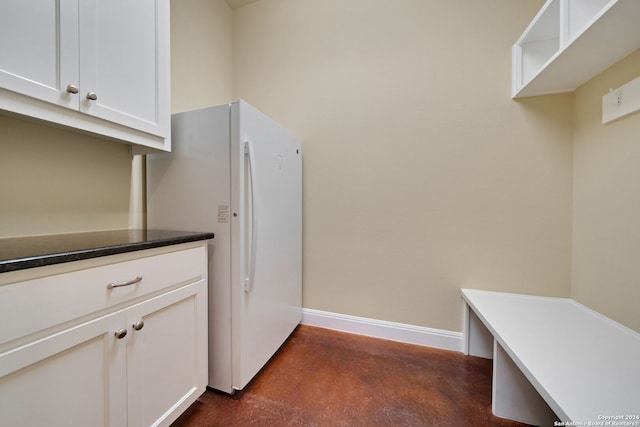 kitchen with white refrigerator and white cabinets