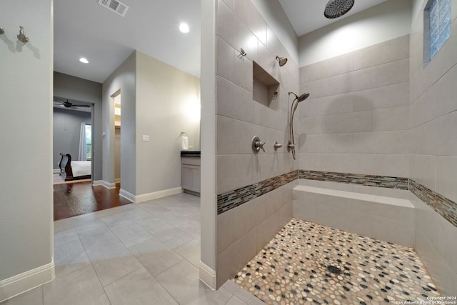 bathroom featuring tiled shower, ceiling fan, vanity, and hardwood / wood-style floors