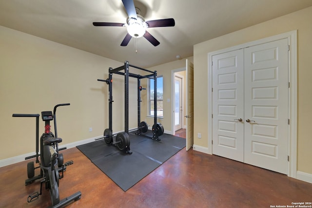 exercise room featuring ceiling fan and concrete flooring