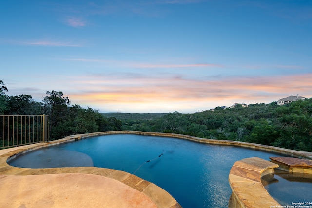 view of pool at dusk