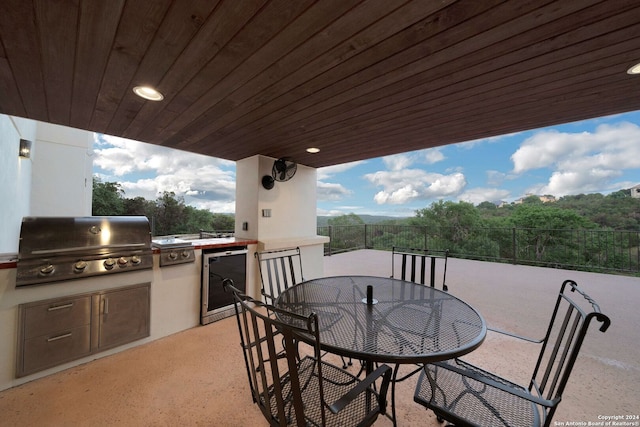 view of terrace with an outdoor kitchen and area for grilling