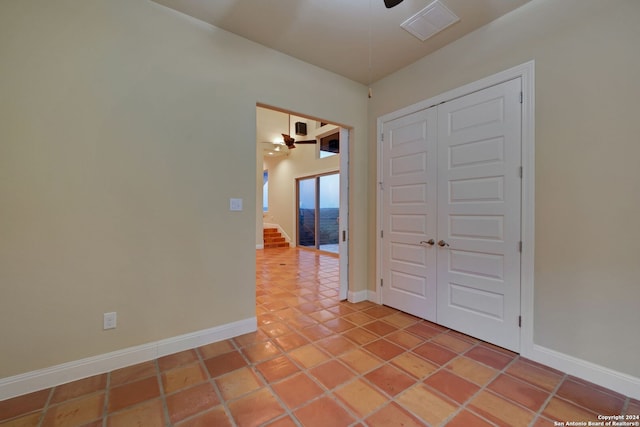 interior space with a closet, ceiling fan, and light tile floors