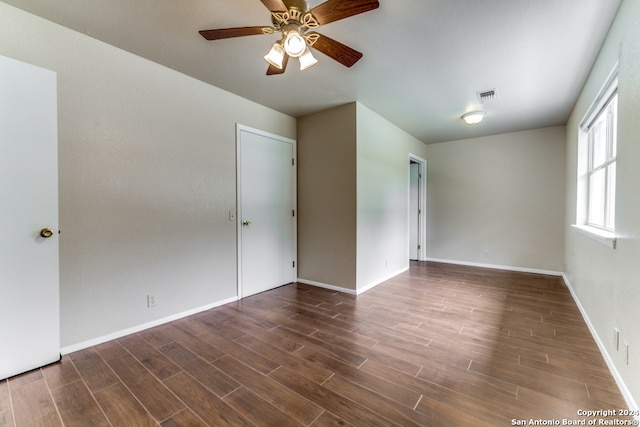 unfurnished room with ceiling fan and dark hardwood / wood-style floors