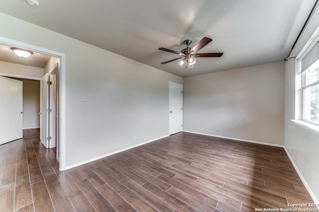 unfurnished room featuring ceiling fan and dark hardwood / wood-style floors