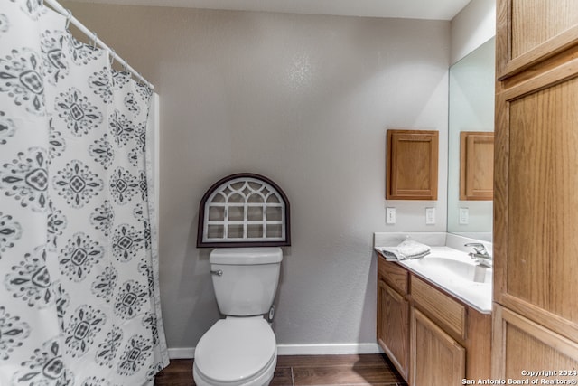 bathroom with hardwood / wood-style floors, oversized vanity, and toilet