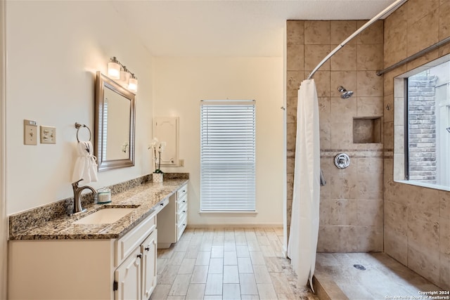 bathroom featuring curtained shower and vanity