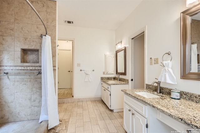 bathroom featuring walk in shower and vanity