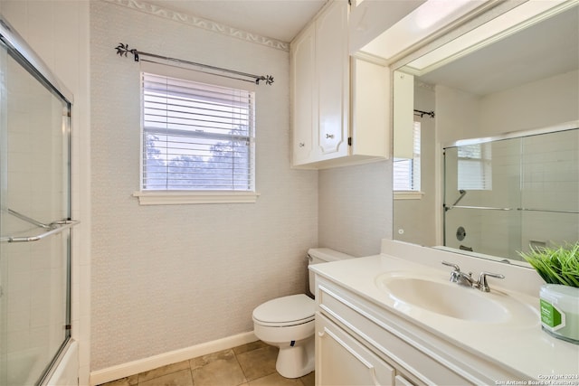 full bathroom with toilet, tile patterned flooring, vanity, and combined bath / shower with glass door