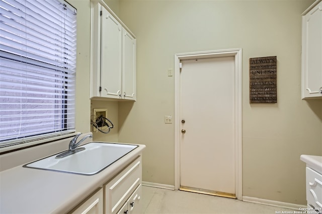 washroom featuring sink, cabinets, and washer hookup