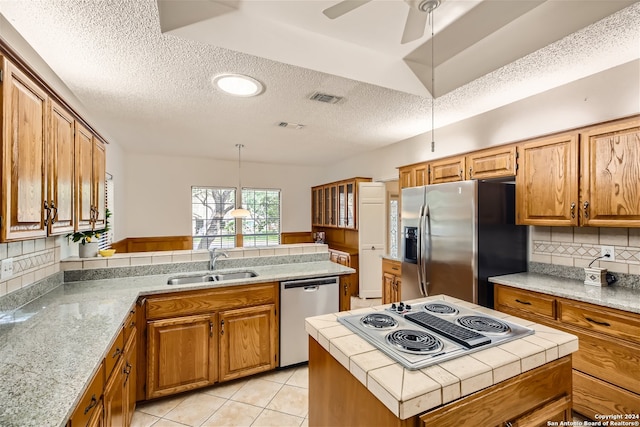 kitchen with stainless steel appliances, sink, a center island, light tile patterned flooring, and decorative backsplash