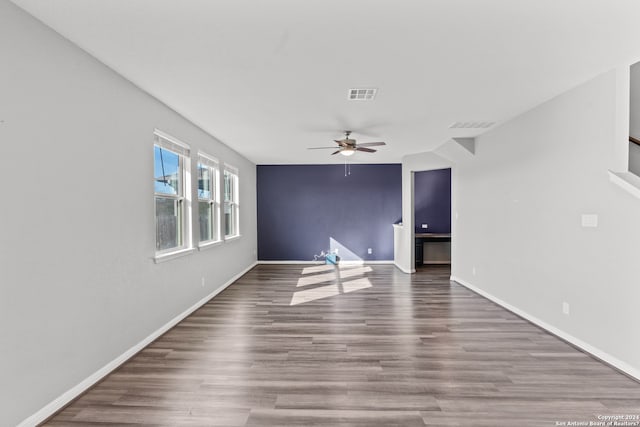 empty room with ceiling fan and hardwood / wood-style flooring