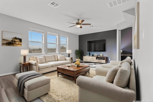 living room featuring hardwood / wood-style flooring and ceiling fan