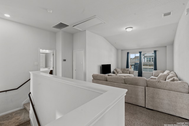 living room featuring carpet floors and lofted ceiling