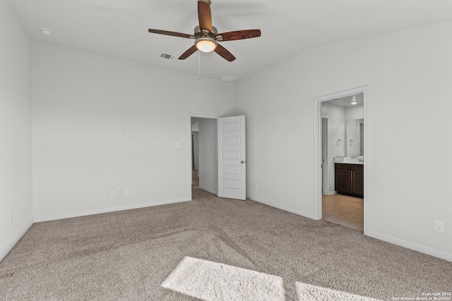 unfurnished bedroom with connected bathroom, carpet, ceiling fan, and vaulted ceiling