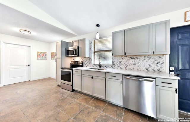 kitchen with tile flooring, backsplash, hanging light fixtures, sink, and appliances with stainless steel finishes