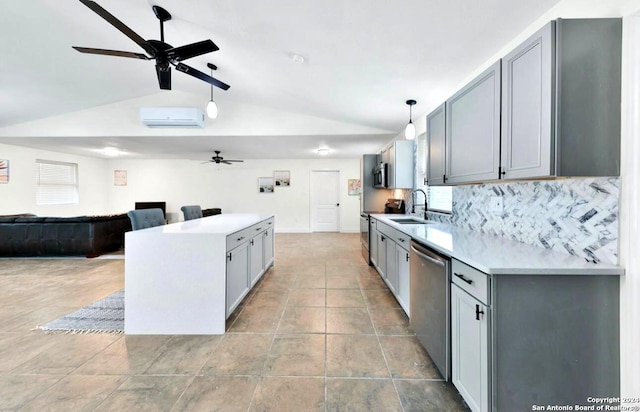 kitchen with decorative light fixtures, ceiling fan, light tile floors, and stainless steel appliances