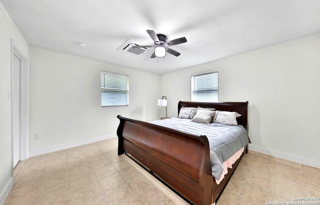 bedroom featuring ceiling fan and light tile floors