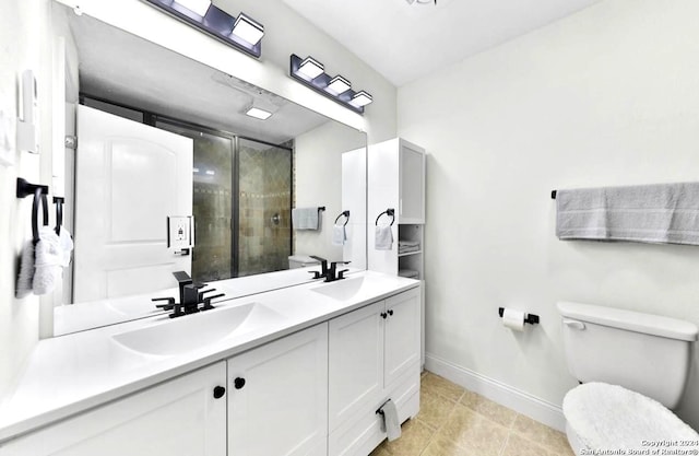 bathroom with tile floors, toilet, and double sink vanity