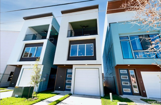 view of property with a garage and a balcony