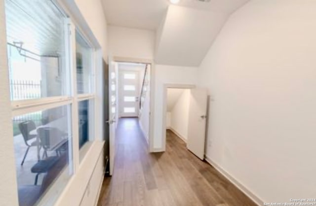 corridor featuring hardwood / wood-style floors