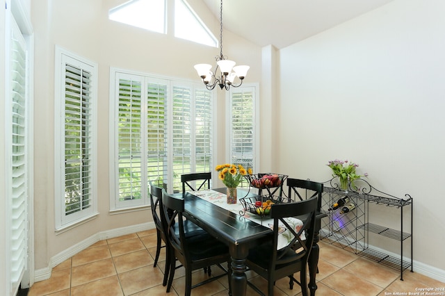 tiled dining space with an inviting chandelier and lofted ceiling