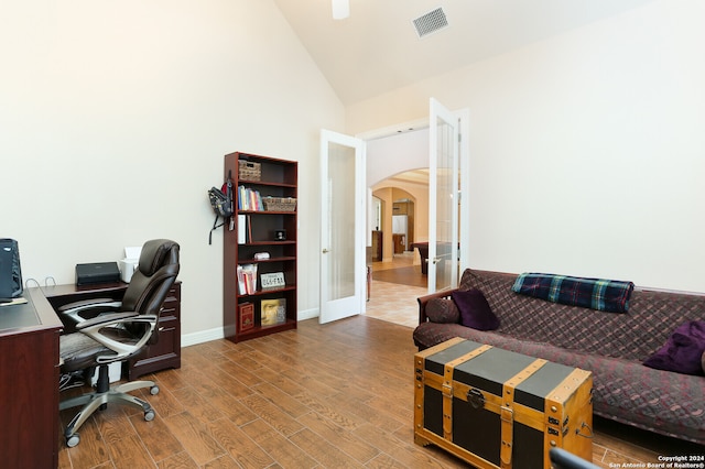 office featuring high vaulted ceiling, wood-type flooring, and french doors