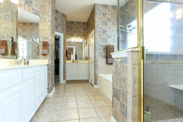 bathroom with tile patterned flooring, tile walls, and plenty of natural light