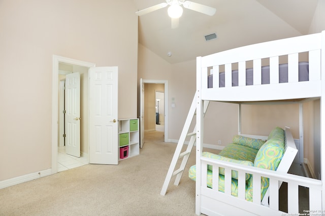 bedroom featuring ceiling fan, high vaulted ceiling, and light carpet