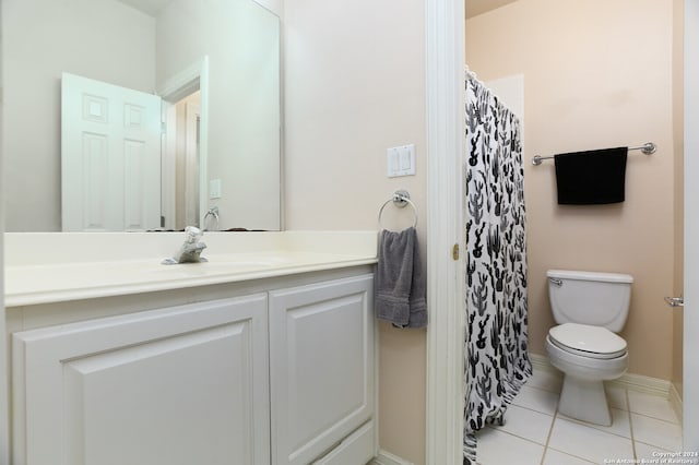 bathroom featuring toilet, vanity, and tile patterned flooring