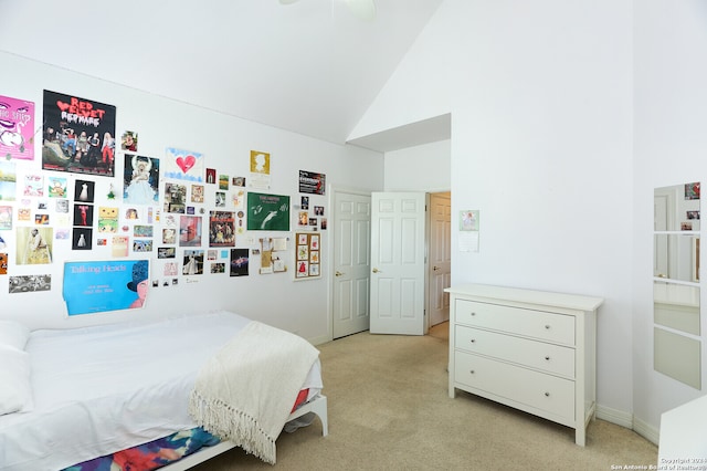 bedroom with ceiling fan, light carpet, and lofted ceiling