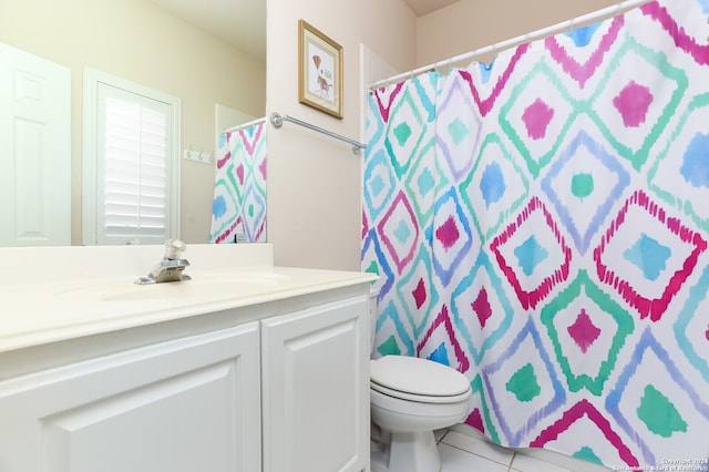 bathroom featuring toilet, vanity, and tile patterned floors