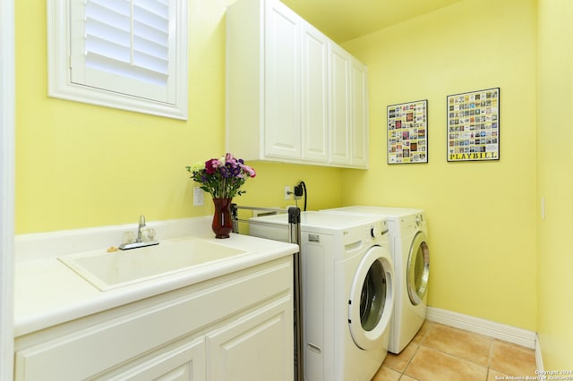 clothes washing area featuring cabinets, light tile patterned flooring, washer and clothes dryer, and sink