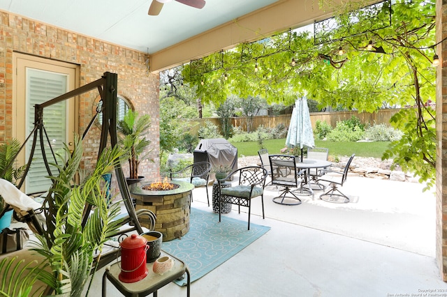 view of patio / terrace with ceiling fan, an outdoor fire pit, and area for grilling