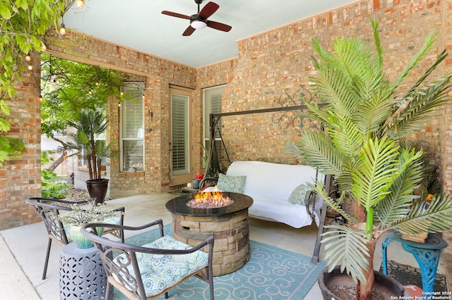 view of patio / terrace featuring ceiling fan and a fire pit